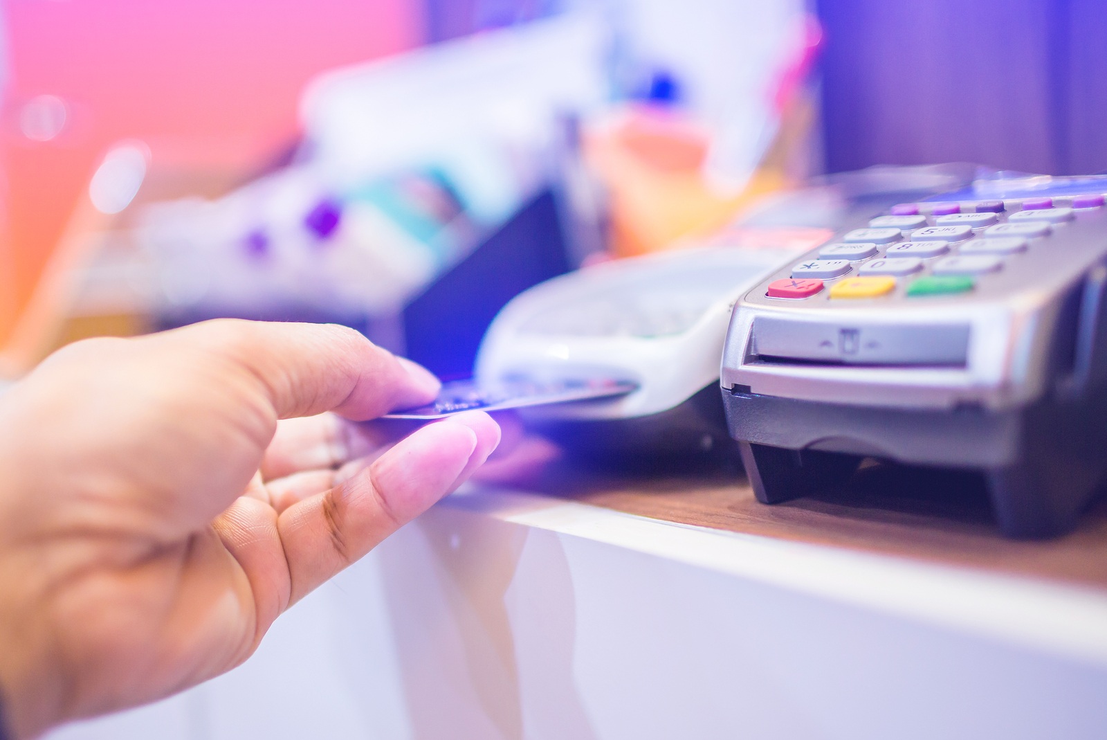 Hand put credit card In slot of credit card reader, credit card payment, buy and sell products & service, the concept of payment without cash, selective focus.