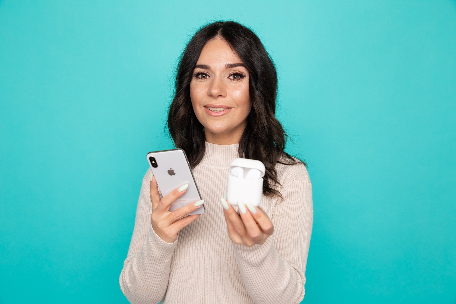 Beautiful young woman listening to the music on the phone by airpods.