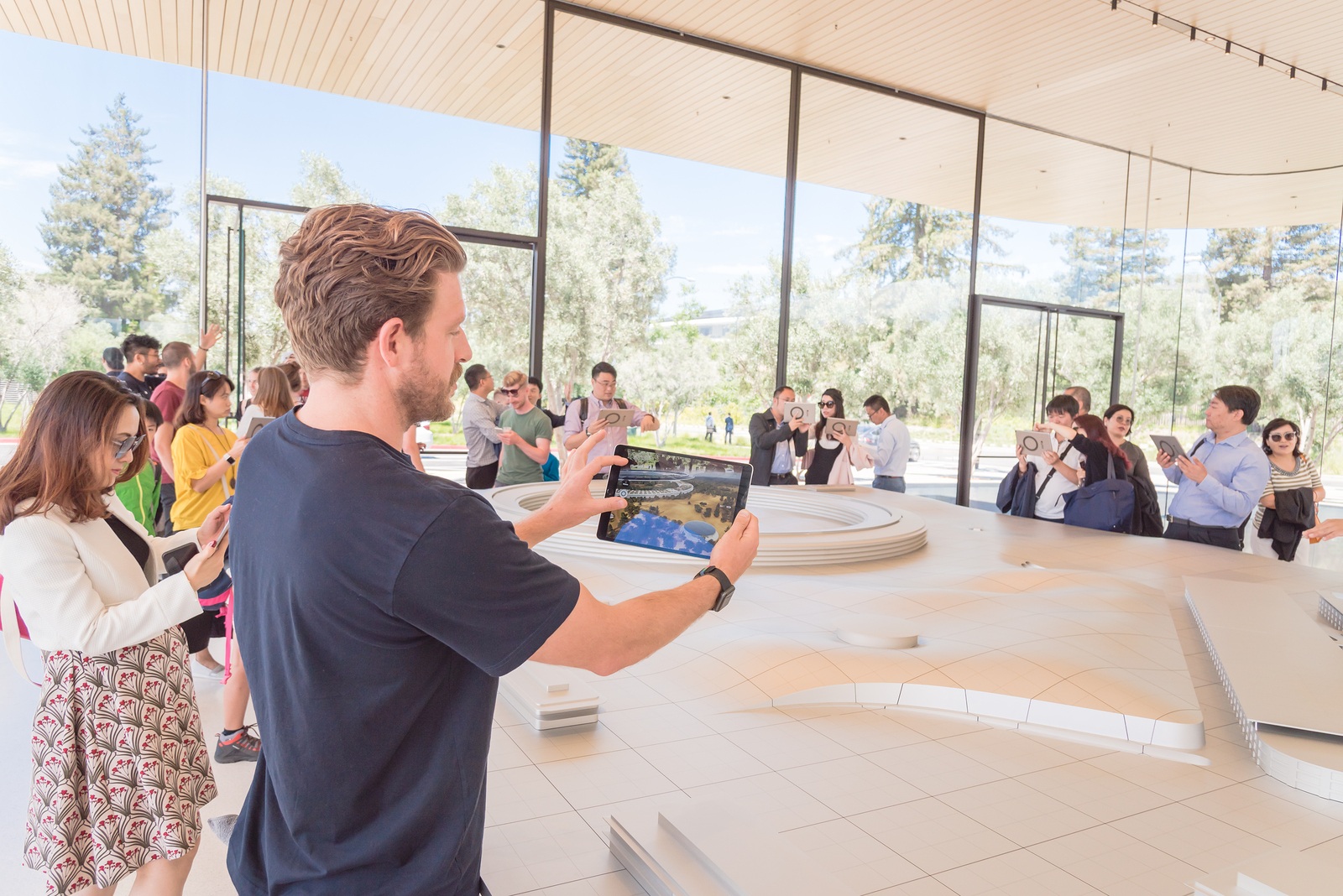 CUPERTINO, CA, US-JUL 18, 2018:Guests enjoy to learn, explore the showcases innovative design principles of Apple Park via three-dimensional model of the campus by augmented reality technology