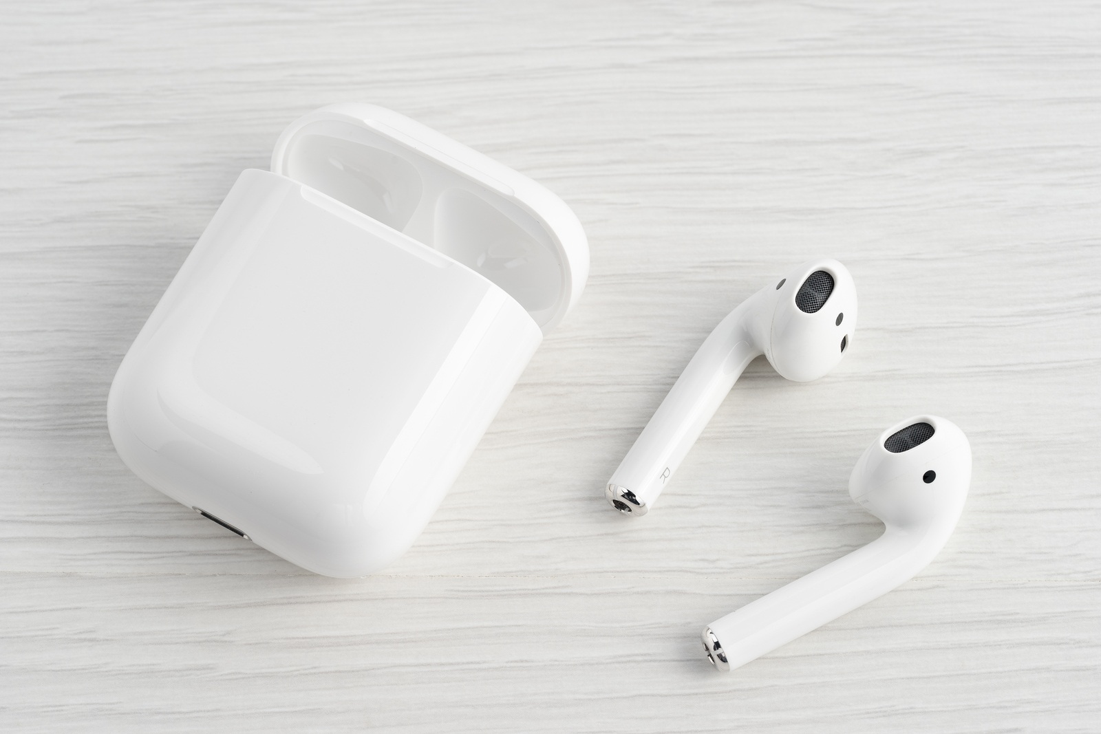 UFA RUSSIA - OCTOBER 20 2017: AirPods wireless bluetooth headphones developed by Apple Inc. Apple Airpods in open box.