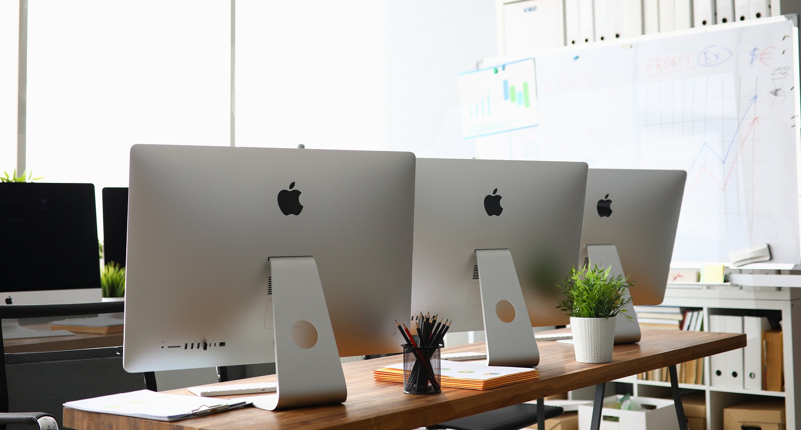 Minsk, Belarus - 88 September 2019: Many apple imac computer aganist empty office background. Illustrtive editorial image.