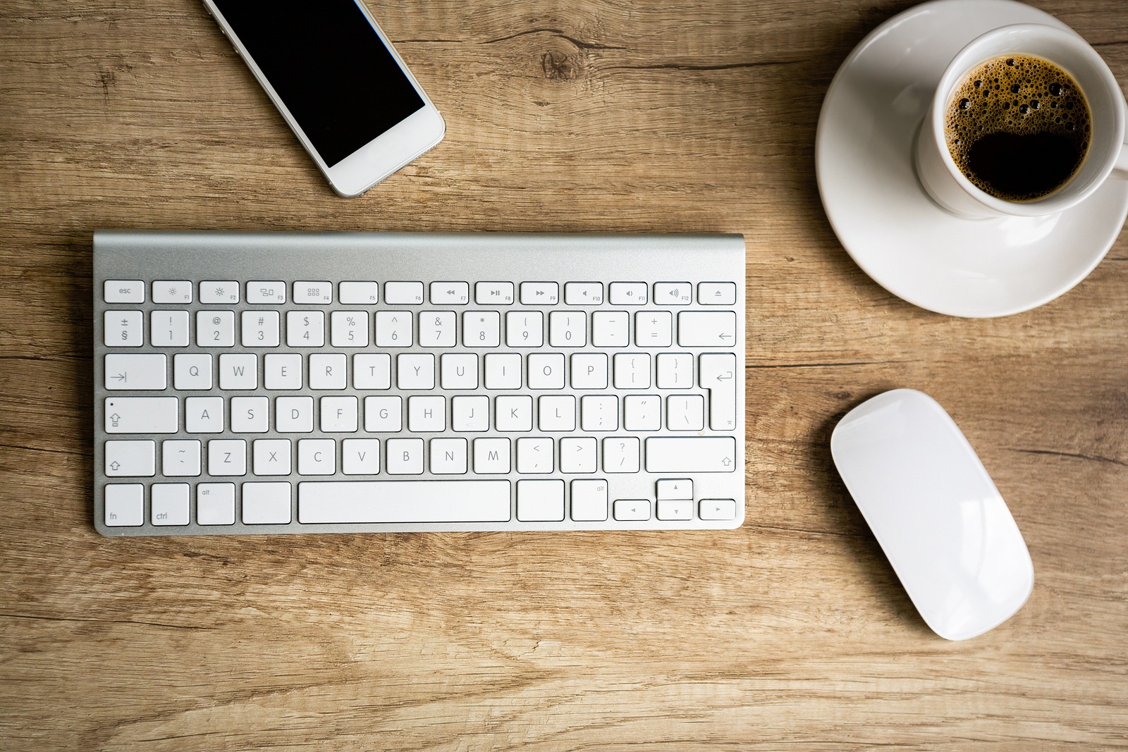 Modern workspace, keyboard and  coffee cup over wooden table