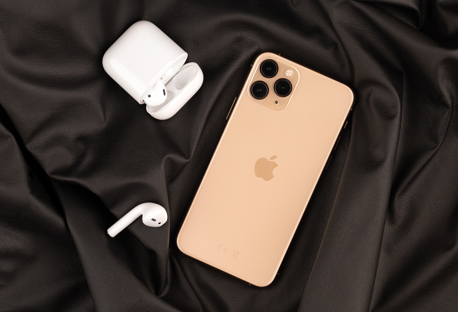 Rostov-on-Don, Russia - october 2019. Apple iPhone 11 Pro on a wooden surface. Apple's new smartphone close-up. Smartphone and AirPods earphones.