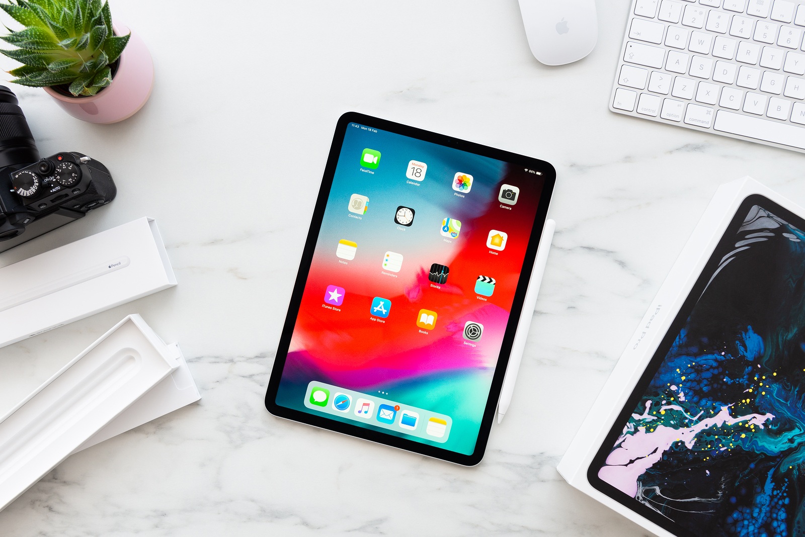 ZAGREB, CROATIA - FEBRUARY 18, 2019: Apple iPad Pro 11 inch with Apple Pencil 2 on white marble background. Newly opened iPad Pro 11 inch and Apple Pencil 2 surrounded by boxes. Top view.