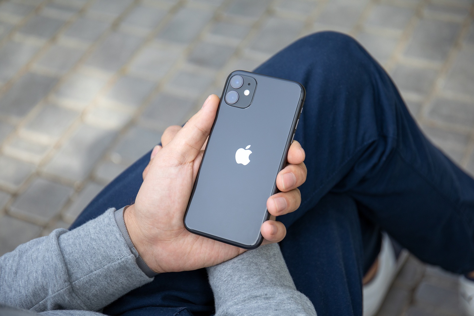 Anapa, Russia - September 26, 2019: Man hand with Apple Watch Series 5 holding iPhone 11. iPhone and Apple Watch was created and developed by the Apple inc.