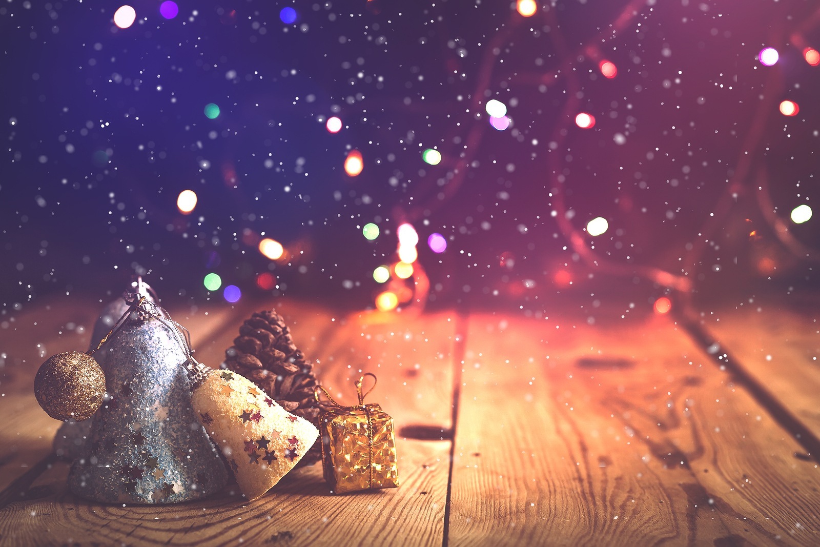 Christmas decor with bright bokeh lights. Magic Winter at Christmas Time. Xmas decoration with Christmas toys and balls on vintage wooden desk. Advent Christmas Decorations. Copy space for text and ad