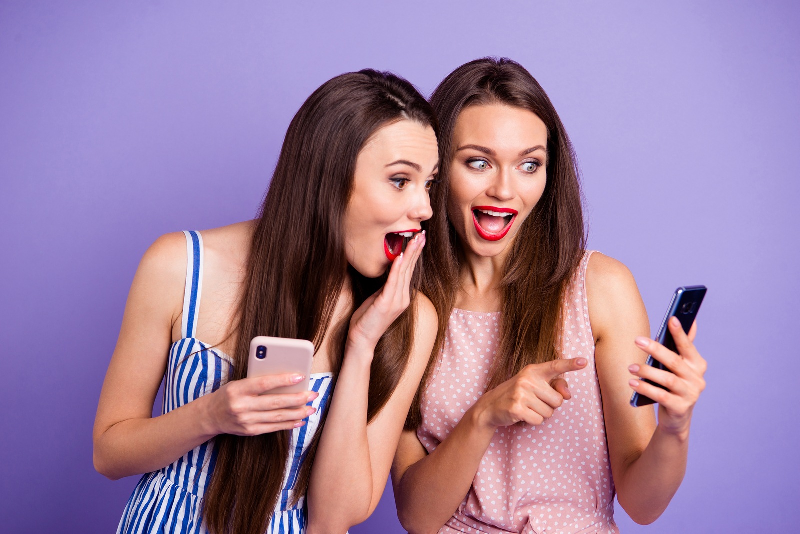 Close up photo two people beautiful funny funky she her models ladies millennials joke boyfriend picture telephone smart phone using showing wear colorful dresses isolated purple violet background