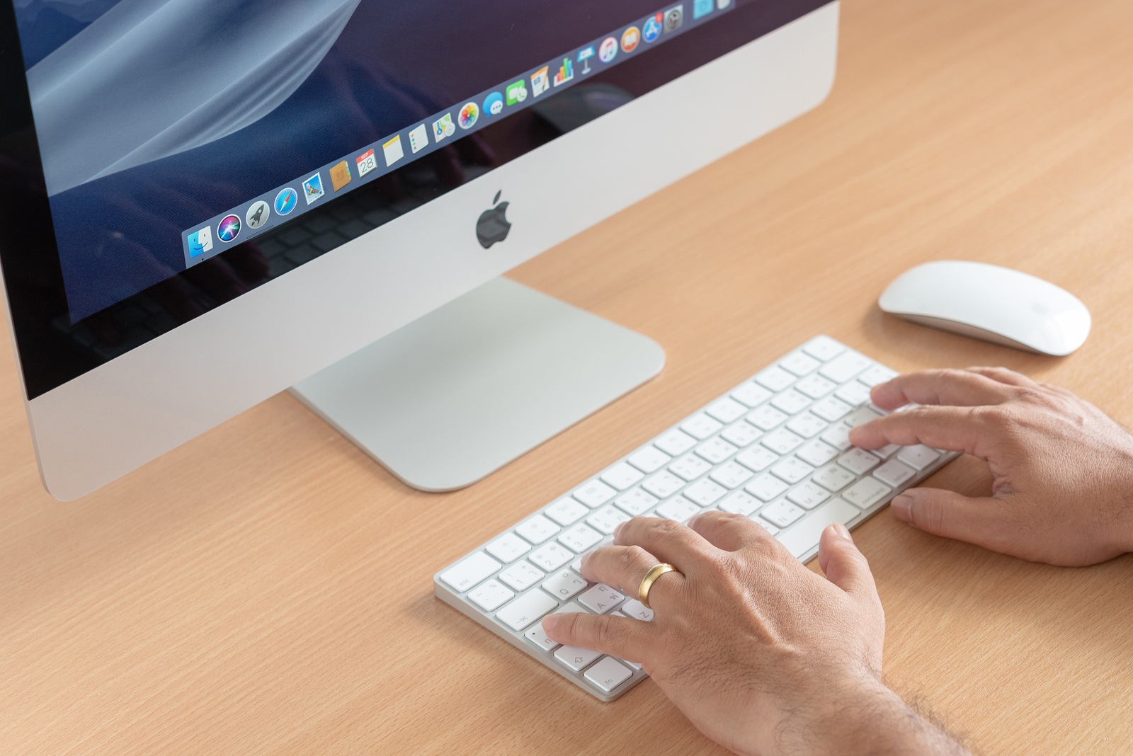 PHATTHALUNG, THAILAND - September 28, 2018: iMac computer, keyboard, magic mouse on wooden table, created by Apple Inc.