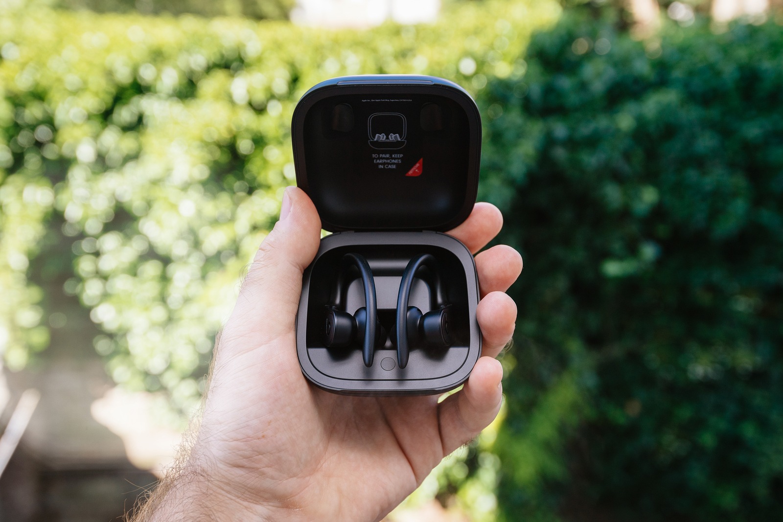 Paris, France - Jun 17, 2019: Powerbeats Pro Beats by Dr Dre wireless high-performance earphones charging case after unboxing man hand holding admiring the new music device