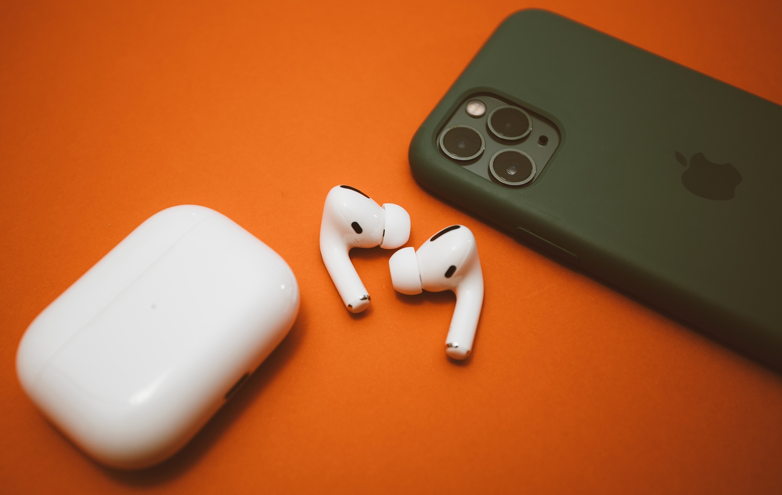 Paris, France - Oct 30, 2019: Charging case and the new iPhone 11 Pro next to New Apple Computers AirPods Pro headphones with Active Noise Cancellation for immersive sound