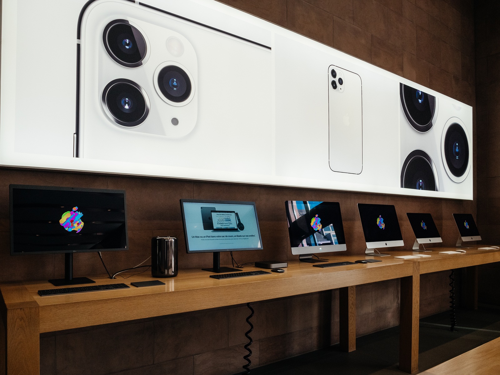 Paris, France - Sep 20, 2019: The new iPhone 11, 11 Pro and Pro Max advertising with triple camera in Apple Store as the smartphone by Apple Computers goes on sale next to Mac Pro iMac