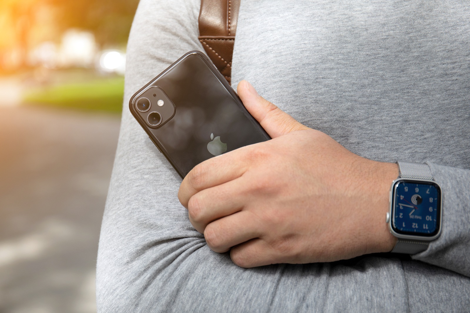 Anapa, Russia - September 26, 2019: Man hand with Apple Watch Series 5 holding iPhone 11. iPhone and Apple Watch was created and developed by the Apple inc.