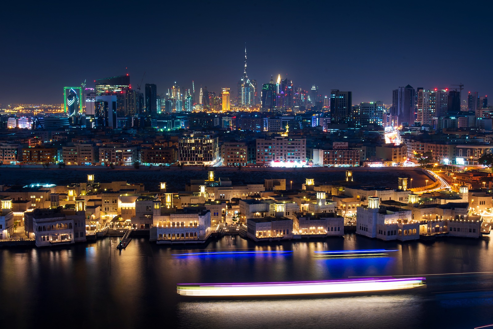 Dubai, United Arab Emirates - June 4, 2019: Dubai modern skyline panoramic view from the creek in Deira in United Arab Emirates at blue hour