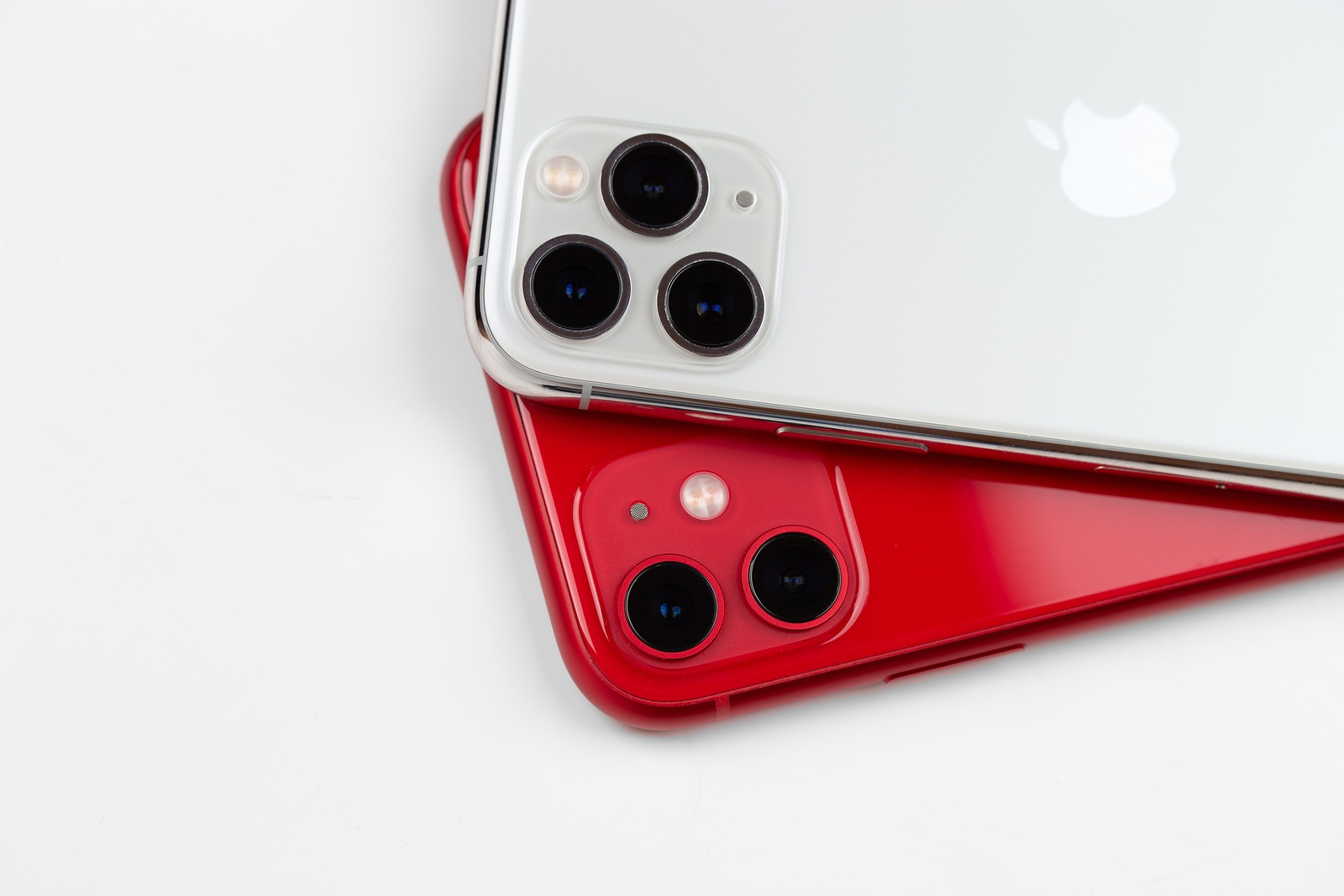 Rostov-on-Don, Russia - November 2019. Apple iPhone 11 Red color and Apple iPhone 11 Pro silver color on a white background. New smartphones from the company Apple close-up.