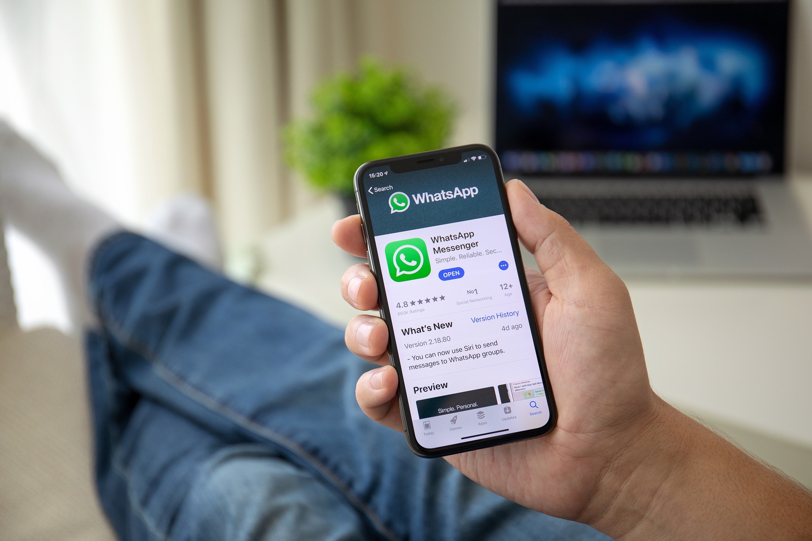 Alushta, Russia - July 29, 2018: Man holding iPhone X with social networking service WhatsApp on the screen. iPhone 10 was created and developed by the Apple inc.