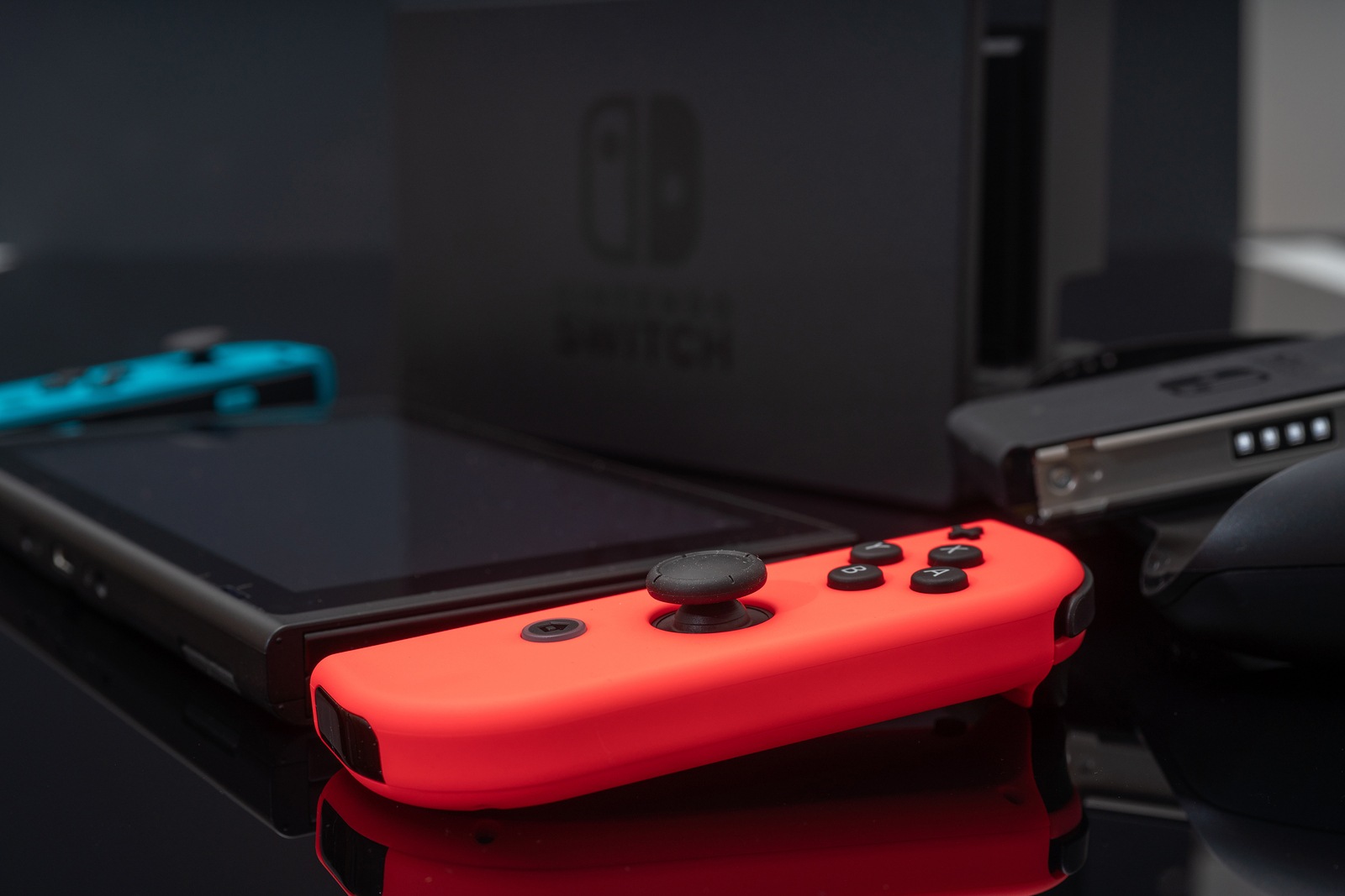 Nintendo Switch video game console developed by Nintendo, released on March 3, 2017 on a black background. Germany, Berlin - June 30, 2019: Nintendo Switch Joy-con controller on a white background