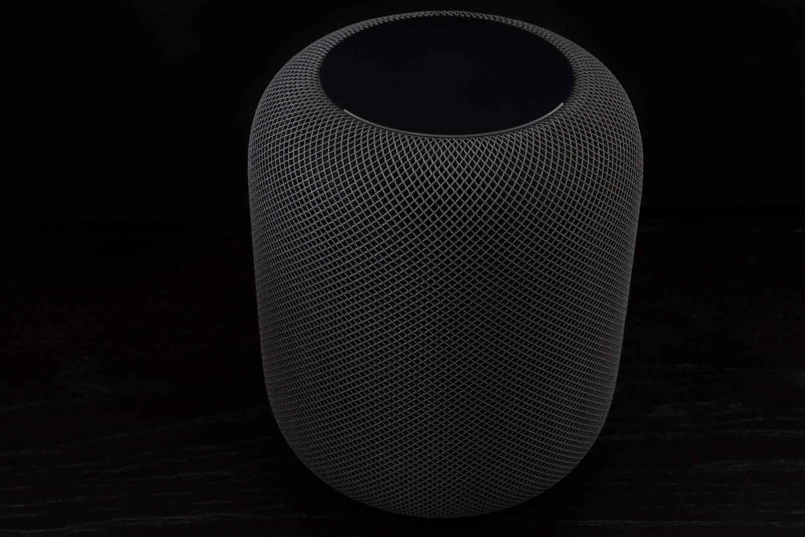 Ostfildern, Germany - June 26, 2018: Using an Apple HomePod speaker - the smart speaker is reacting to voice input, playing music, providing information or steering smart home devices.