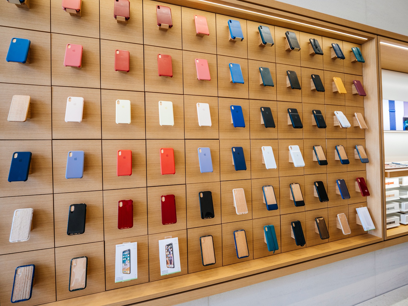 Paris, France - Circa 2019: Apple iPhone smartphone protection cases products are displayed inside the new Apple Store Champs-Elysees largest French store located in the heart of the capital people testing