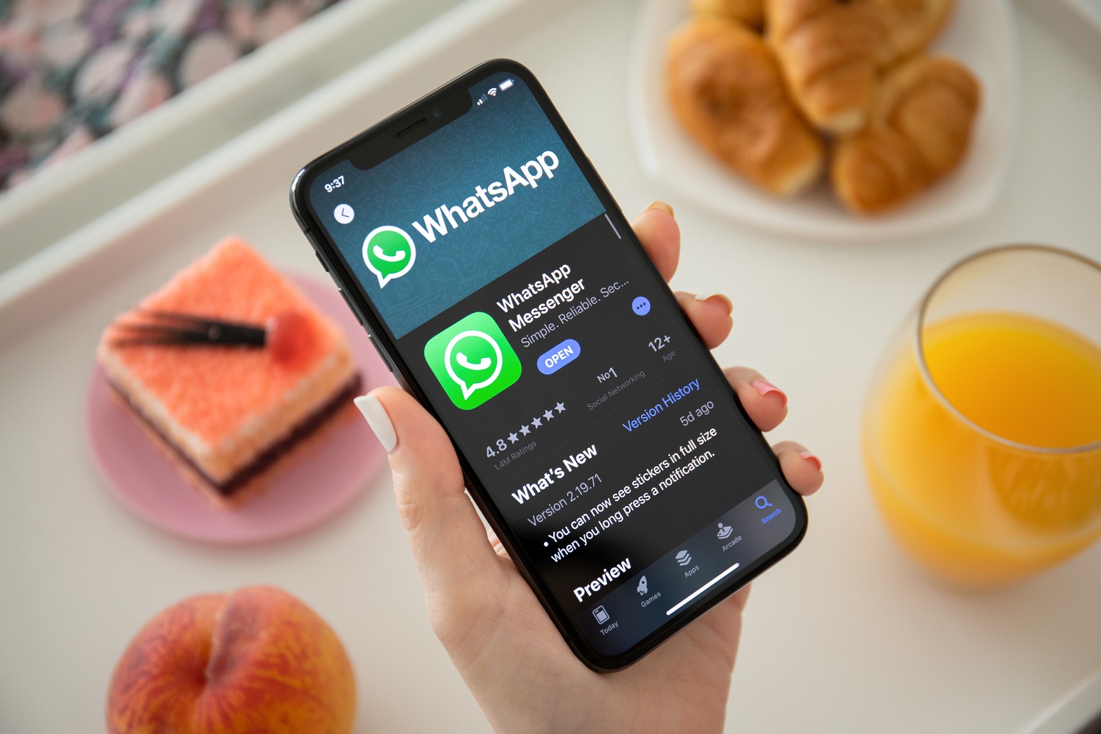 Anapa, Russia - July 23, 2019: Woman holding iPhone X with social networking service WhatsApp on the screen. iPhone was created and developed by the Apple inc.