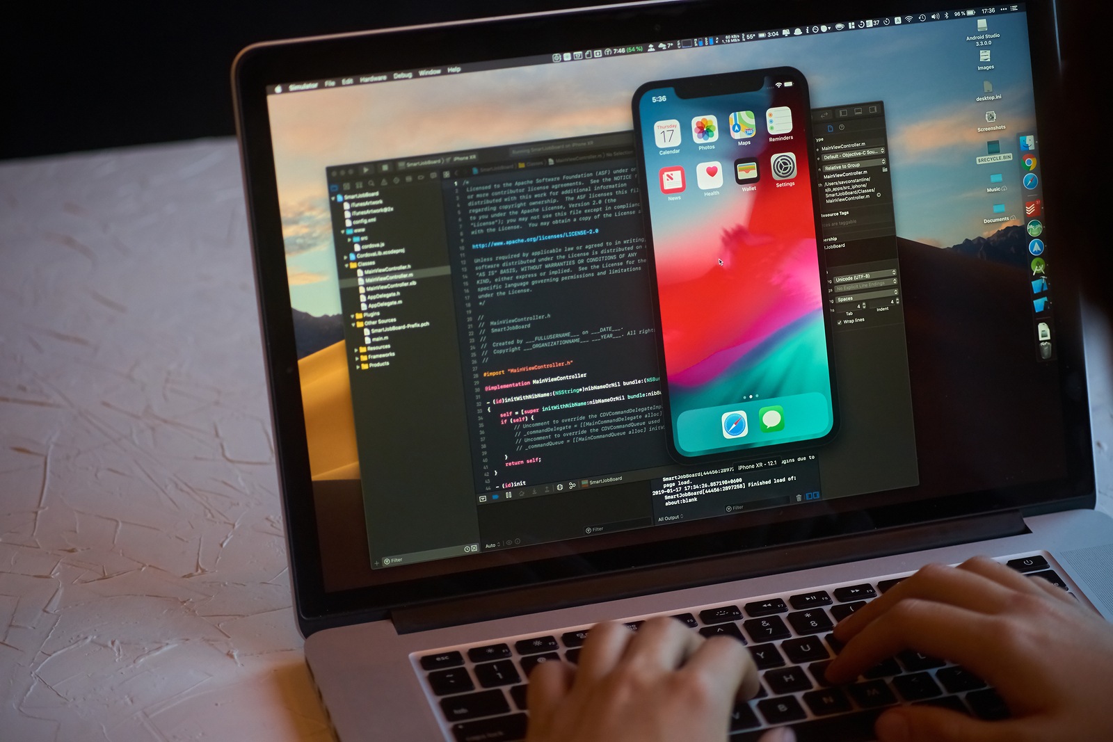 Bishkek, Kyrgyzstan - January 17, 2019: Man developer launches xcode software and ios simulator program to develop ios app on a MacBook