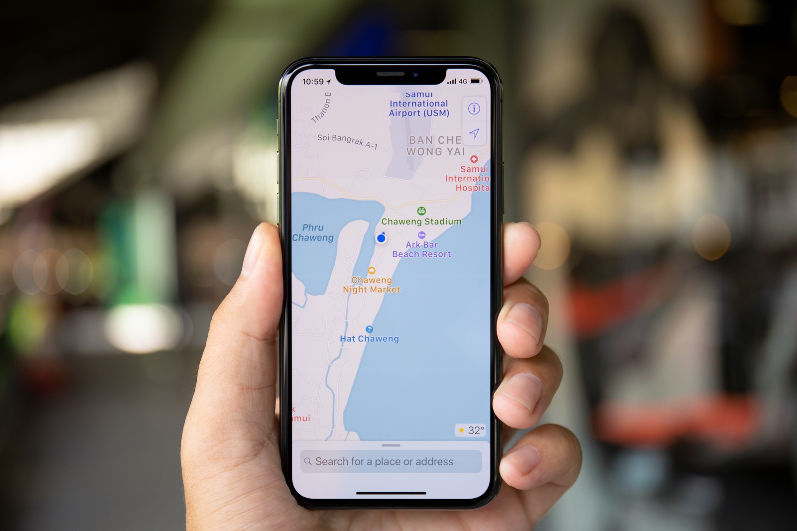 Koh Samui, Thailand - April 15, 2018: Man hands holding iPhone X with application cartographical service Apple Maps in the screen. iPhone 10 was created and developed by the Apple inc.