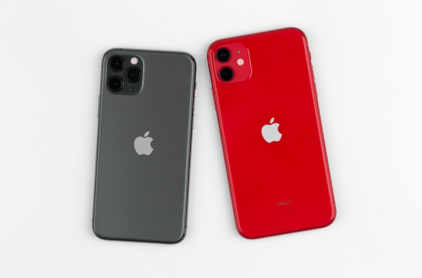 Rostov-on-Don, Russia - November 2019. Apple iPhone 11 PRODUCT RED and Apple iPhone 11 Pro Midnight Green on a white background. Two smartphones from Apple company close-up.