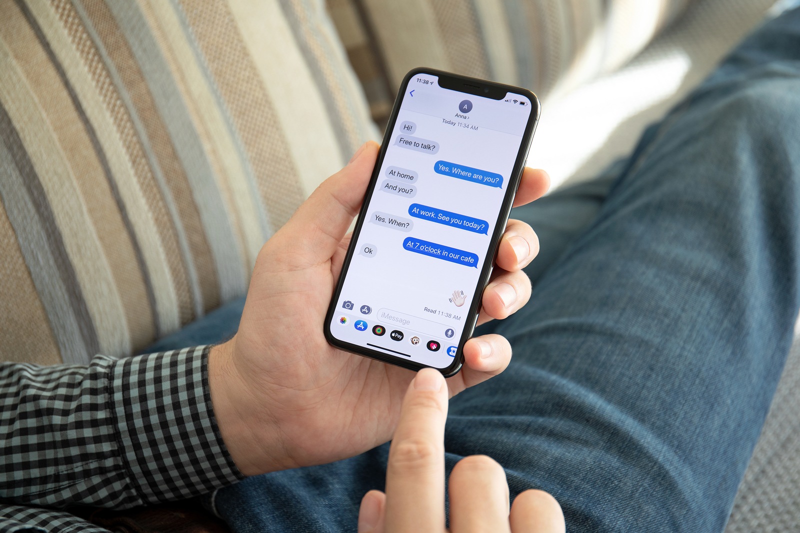 Alushta, Russia - October 9, 2018: Man hand holding iPhone X with social networking service iMessage on the screen. iPhone 10 was created and developed by the Apple inc.