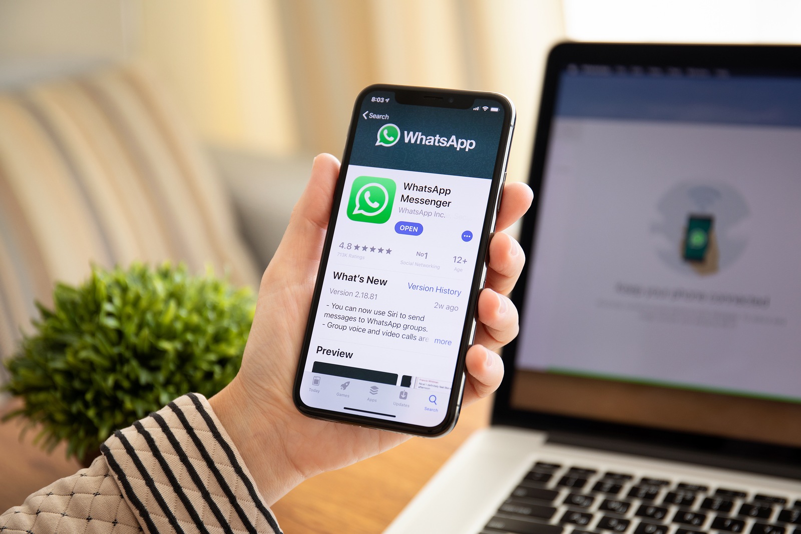 Alushta, Russia - September 26, 2018: Woman holding iPhone X with social networking service WhatsApp on the screen. iPhone 10 was created and developed by the Apple inc.