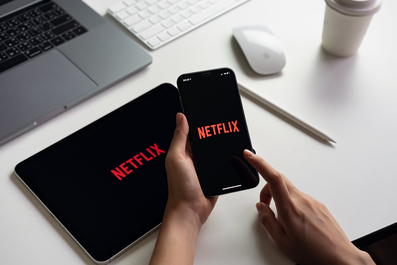 Bangkok, Thailand - March 11, 2019 : women use Netflix app on smartphone screen. Netflix is an international leading subscription service for watching TV episodes and movies.