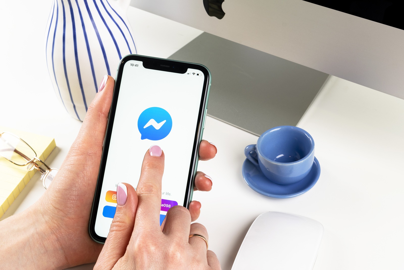 Helsinki, Finland, January 30, 2020: Facebook messenger application icon on Apple iPhone 11 screen close-up in woman hands. Facebook messenger app icon. Social media network. Social media app