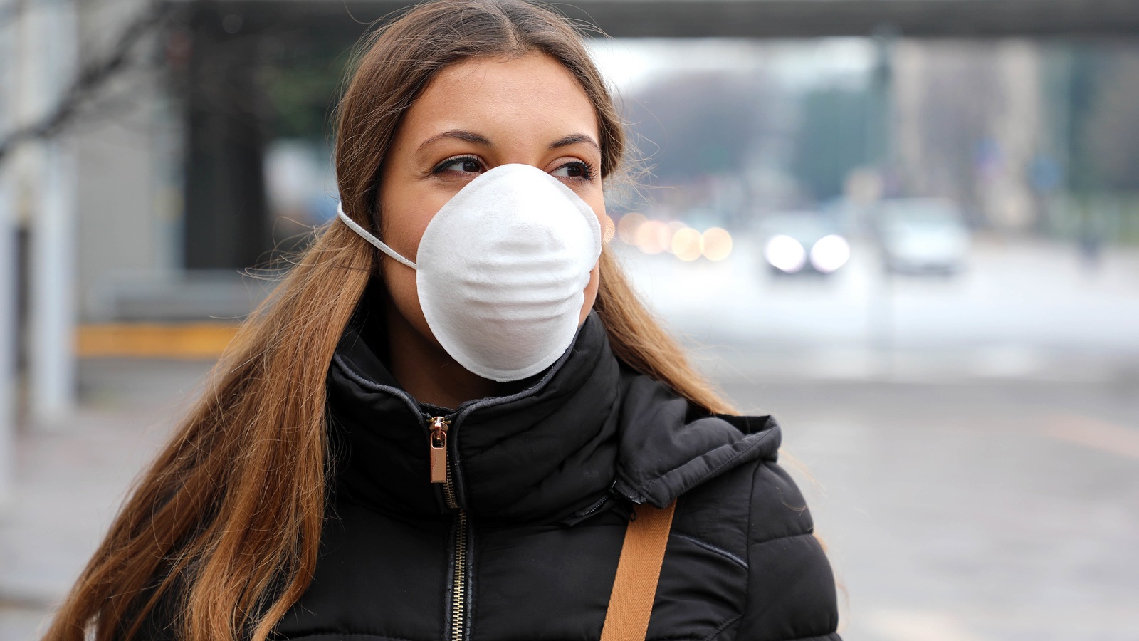 COVID-19 Pandemic Coronavirus Woman with face mask protective spreading flu disease virus, protection against influenza viruses and diseases. Girl wearing mask on face in public spaces of air pollution and particulates.