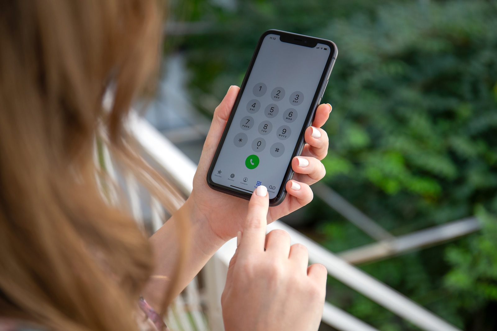 Anapa, Russia - October 4, 2019: Women hands holding iPhone 11 with call number on the screen. iPhone 11 was created and developed by the Apple inc.