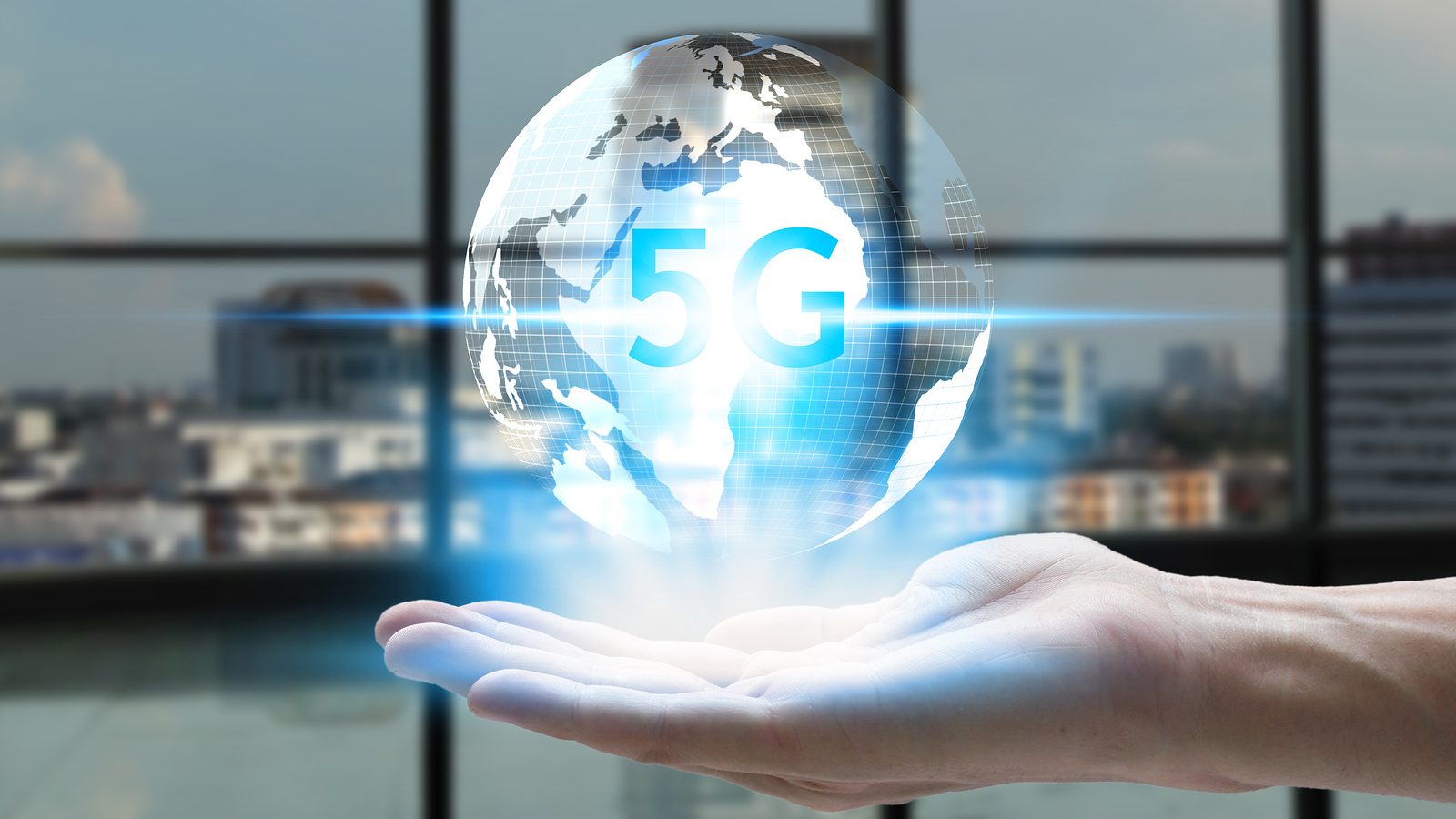 hand holding network using 5G technology with virtual screen icons on the city background, Technology Internet 5G global network concept.