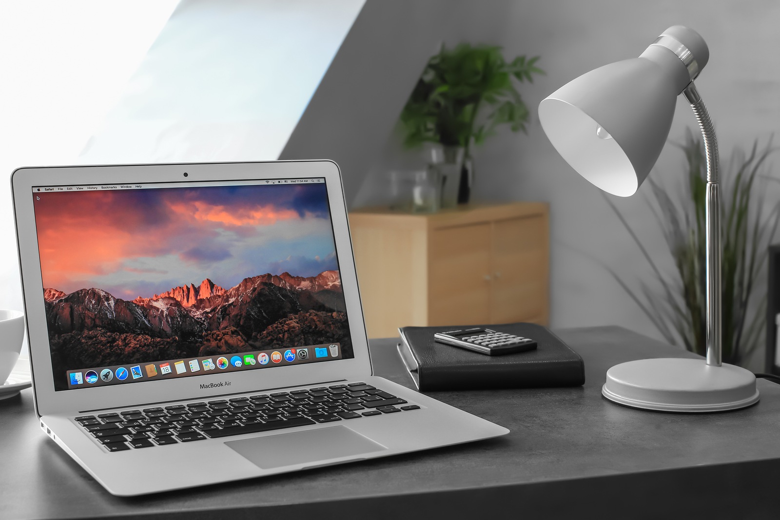 KYIV, UKRAINE - OCTOBER 18, 2017: Apple MacBook Air Silver with desktop screensaver on table indoors