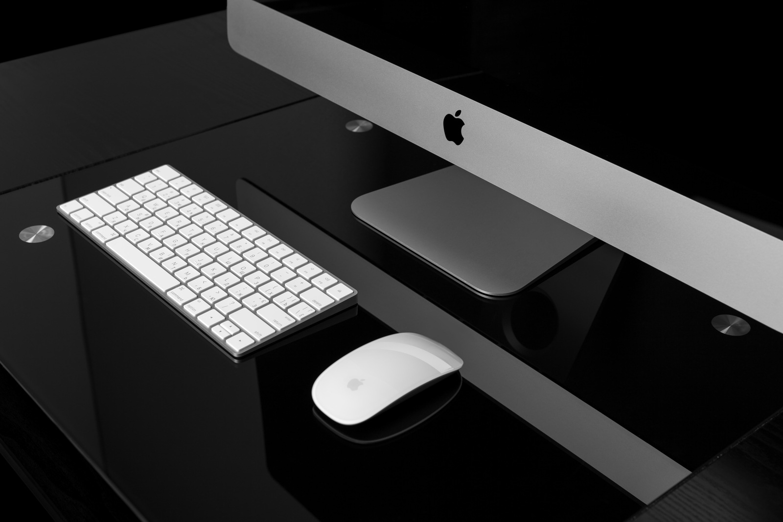 UKRAINE, RIVNE, December 2, 2016. Apple Computer iMac 27 retina display 5K keyboard and magic mouse on black table.