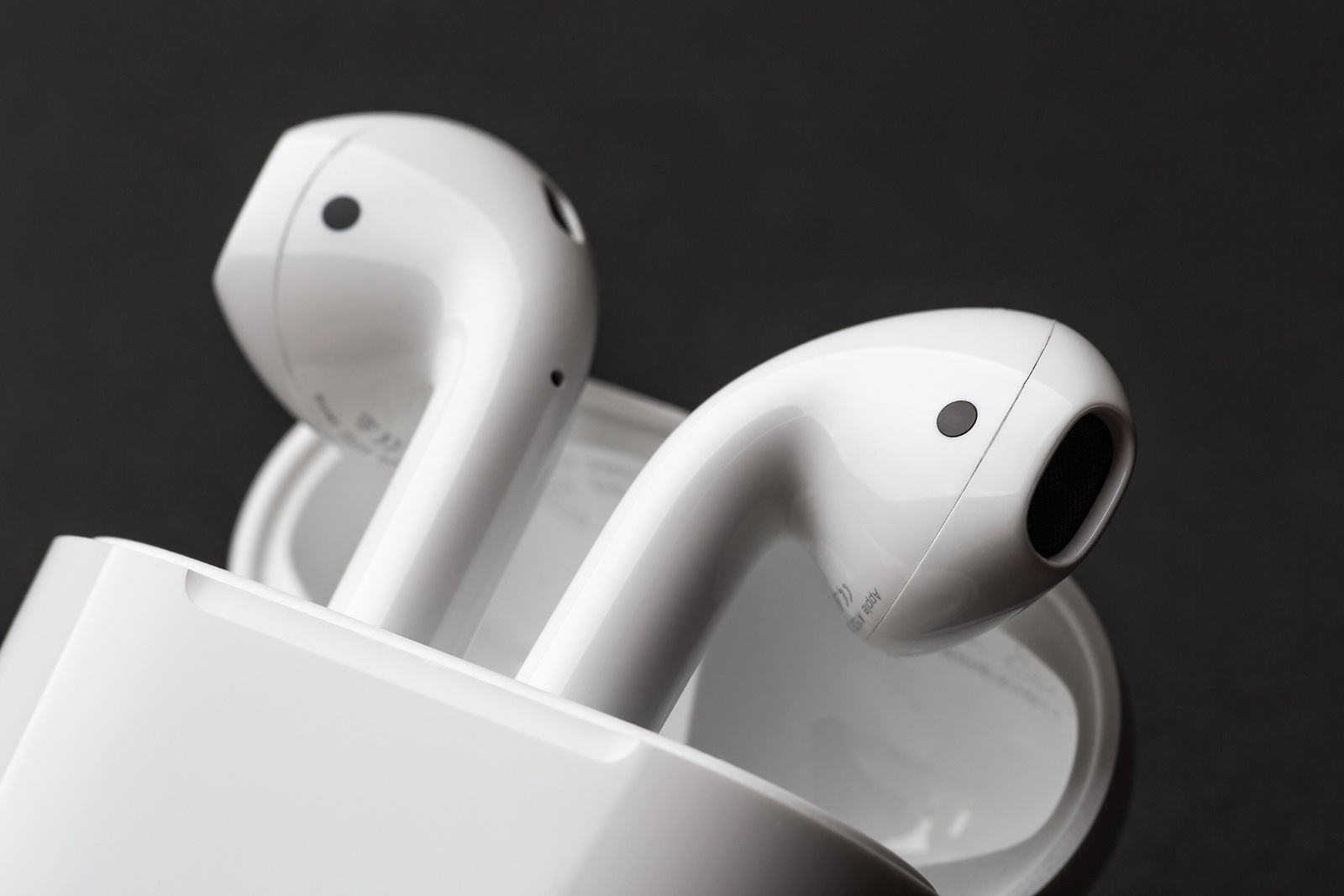 Moscow, Russia - Circa December 2018: Apple AirPods - wireless bluetooth earphones or headphones and white box for storage and charging, use with Iphone, Ipad or Mac.