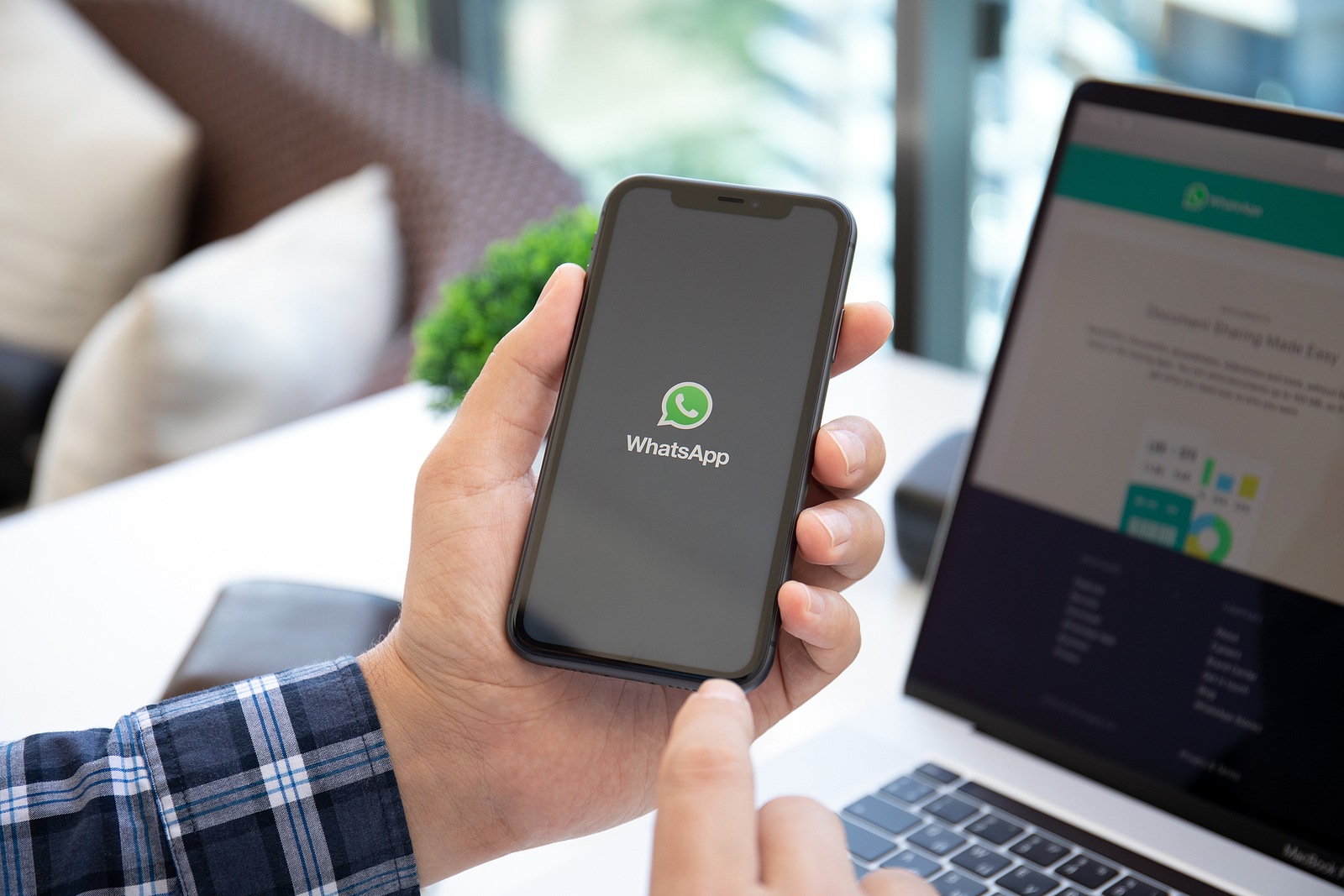 Alanya, Turkey - May 14, 2020: Man holding iPhone 11 with social networking service WhatsApp on the screen. iPhone and Macbook was created and developed by the Apple inc.