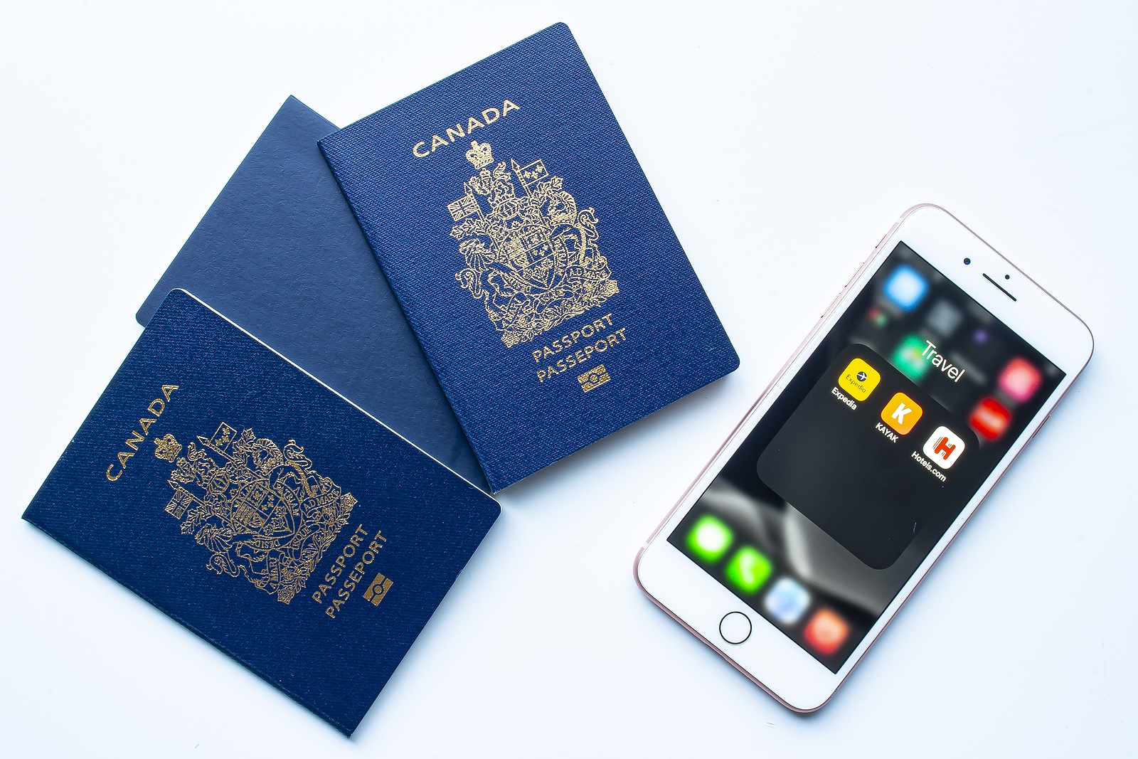 Canadian passports with an iPhone Plus with Expedia, Kayak and Hotels apps. Winnipeg named tourism hotspot by travel site Expedia. Illustrative