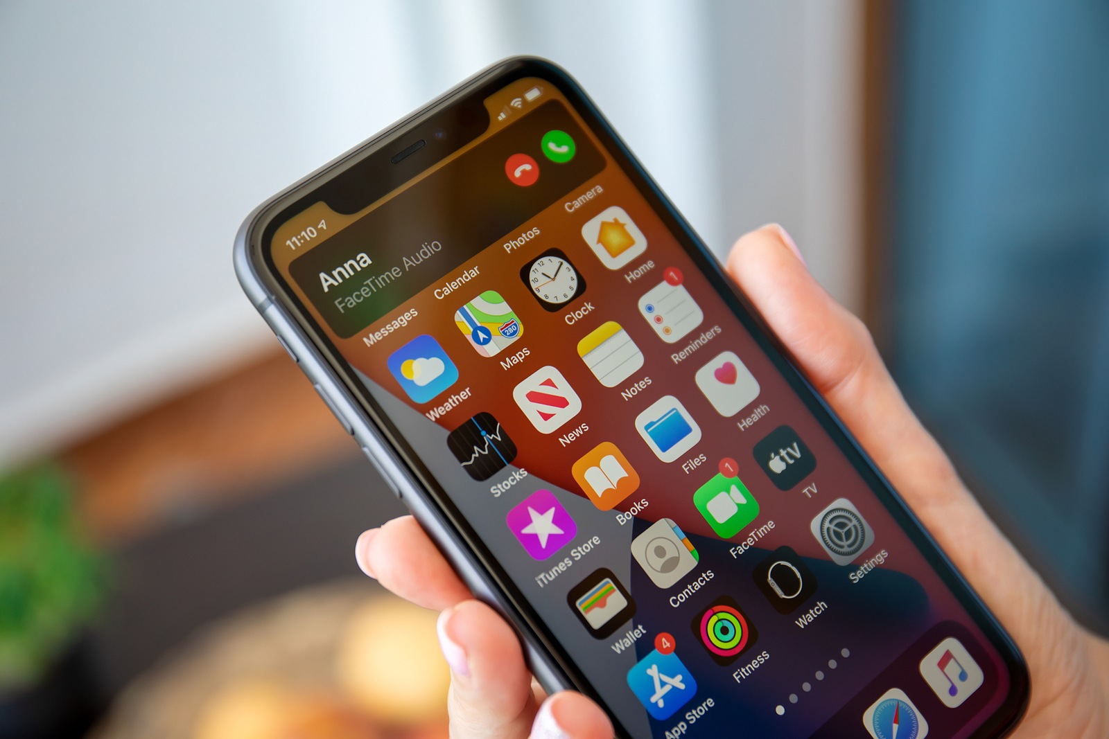 Alanya, Turkey - July 10, 2020: Woman hand holding iPhone 11 with phone call widget on the home screen. iPhone 11 was created and developed by the Apple inc.