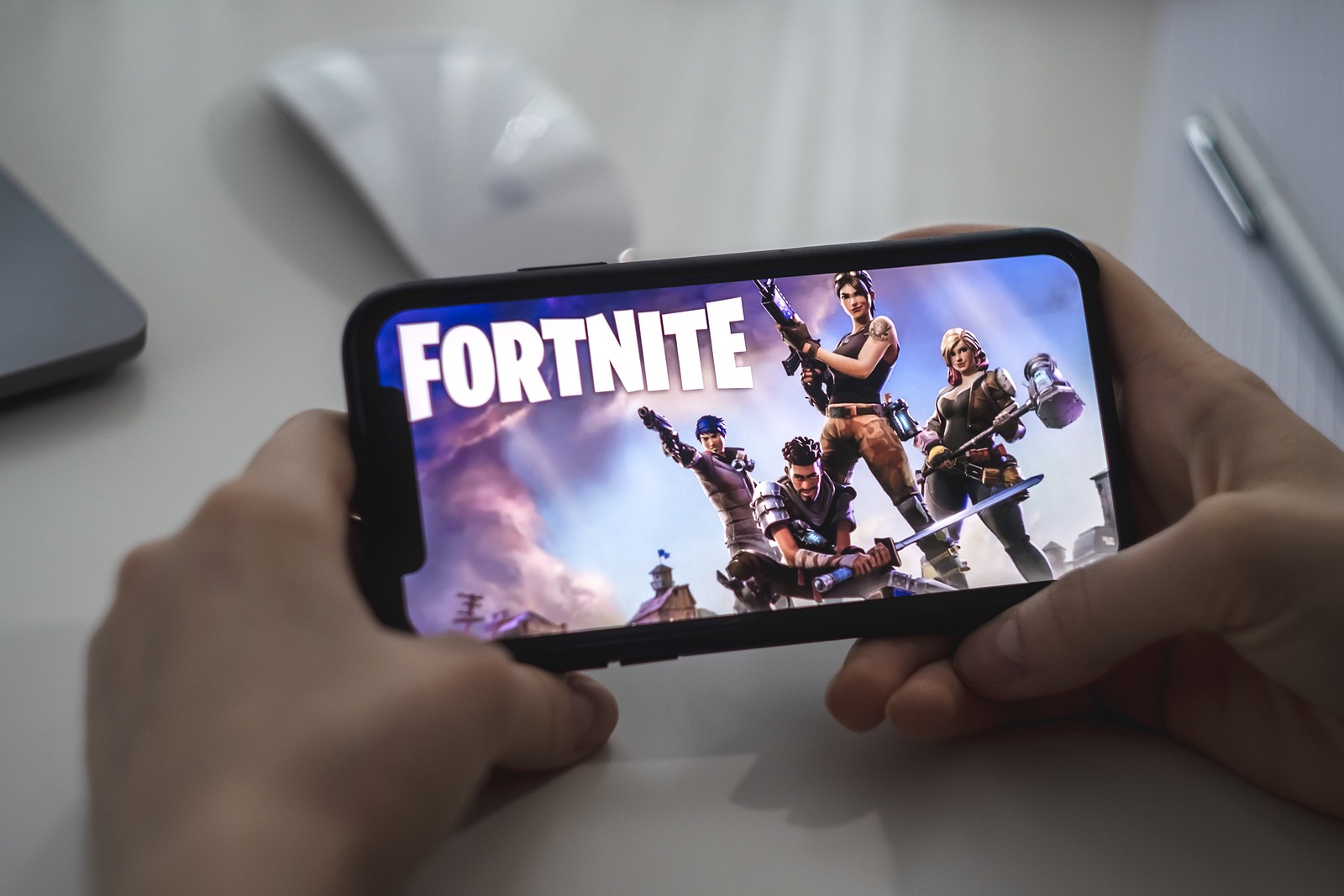 Fortnite game on the iPhone screen. High quality photo