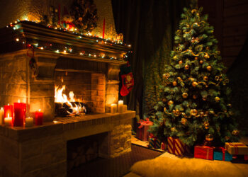 Living room home interior with decorated fireplace and christmas tree